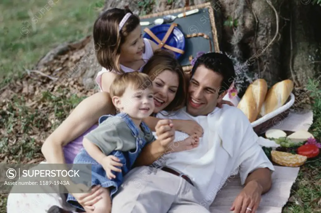 Parents with their son and daughter at a picnic