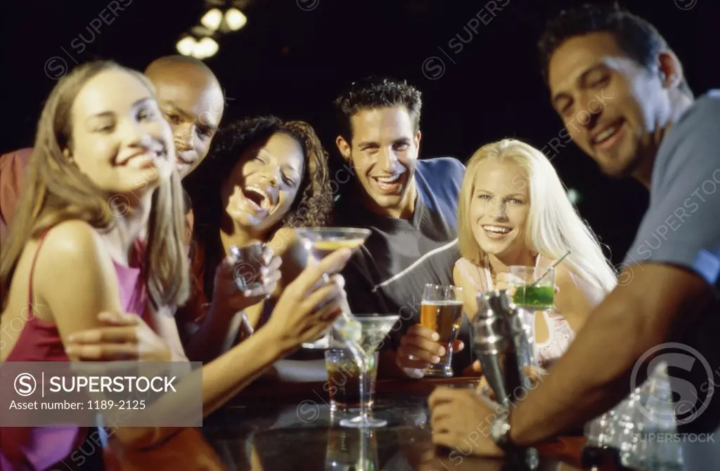 Portrait of a group of young people drinking in a bar