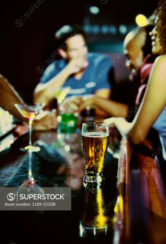Young man with his friends sitting at a bar counter