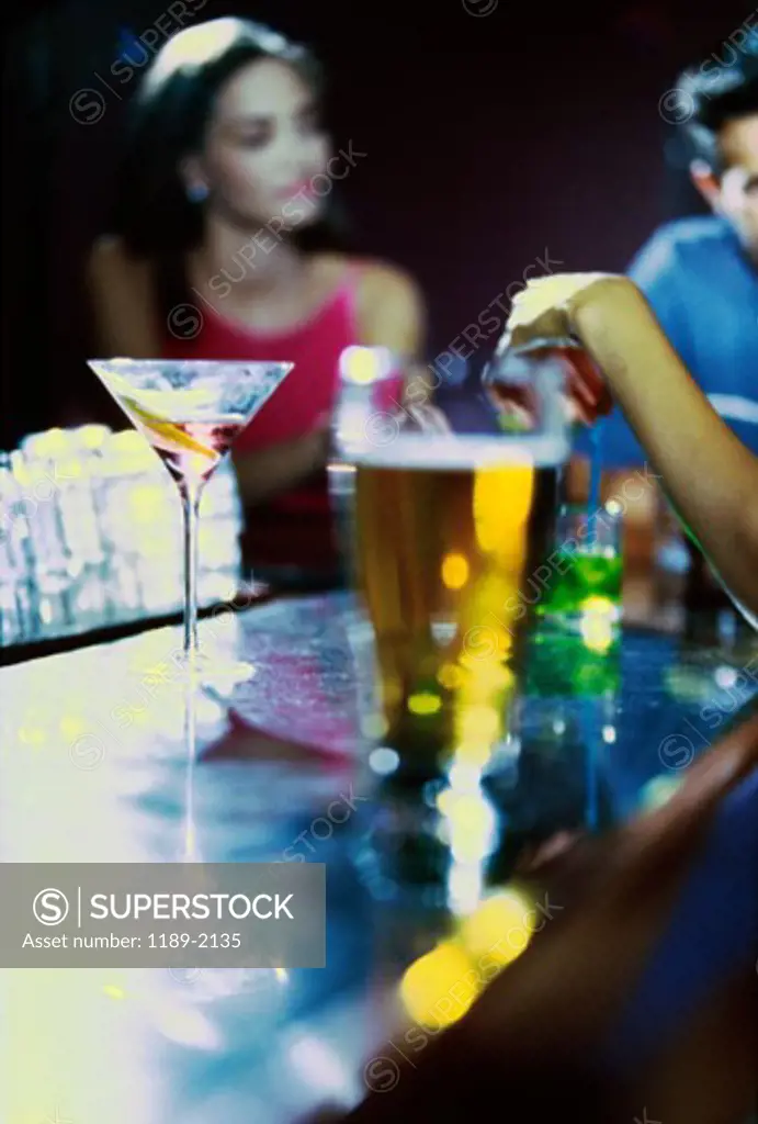 Young woman drinking wine in a bar