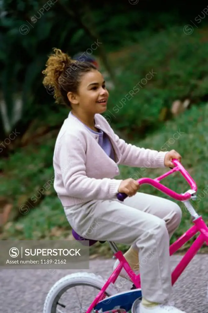 Side profile of a girl riding a bike