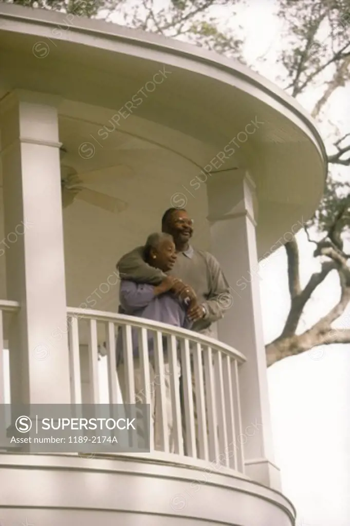 Low angle view of a senior couple standing on the balcony