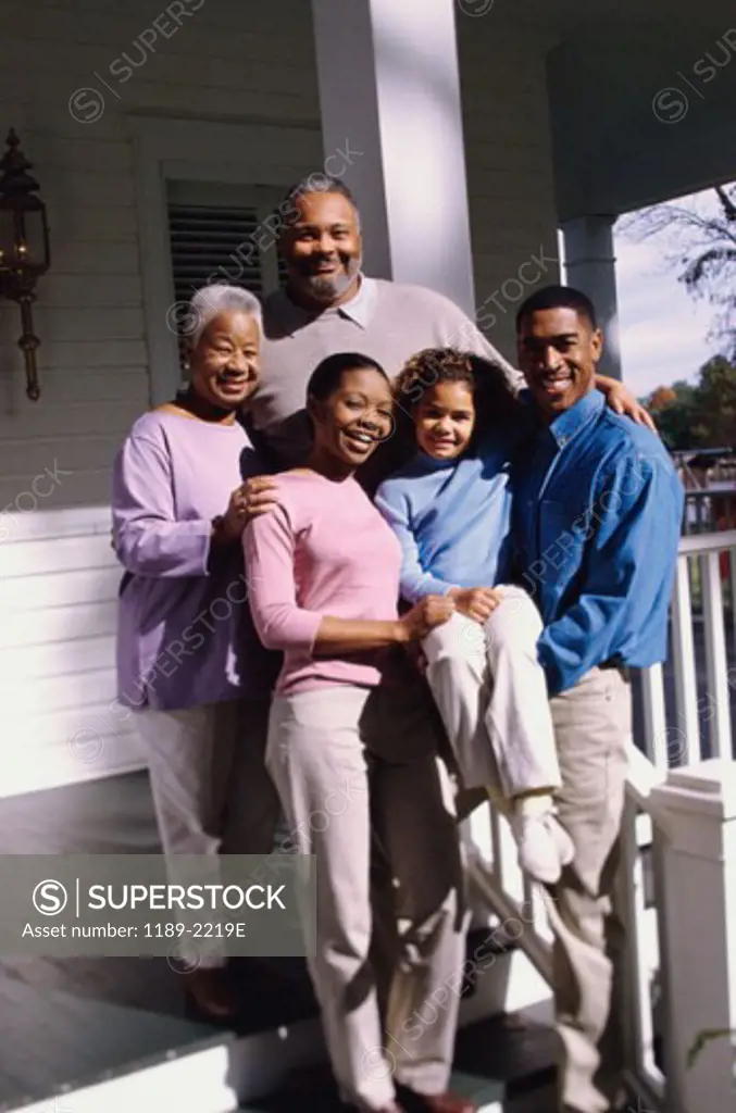 Family standing in front of a house