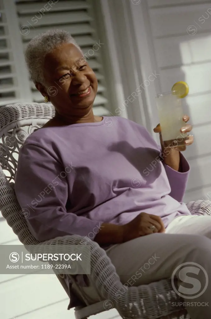 Senior woman holding a glass of lemonade