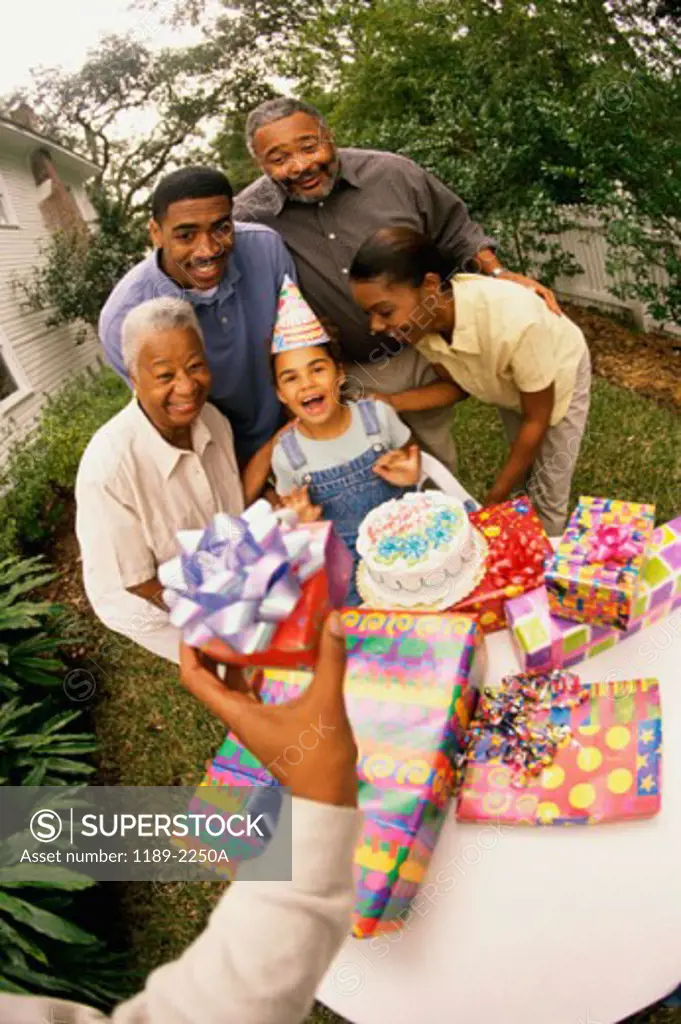 High angle view of a girl celebrating her birthday with her parents and grandparents