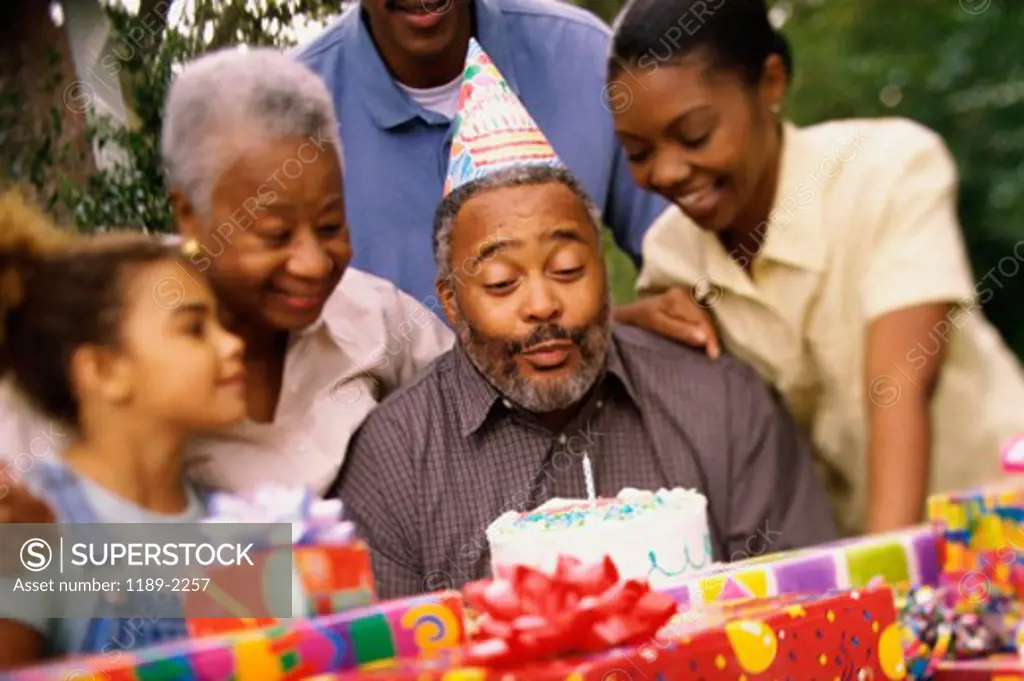 Close-up of three generation family celebrating a birthday