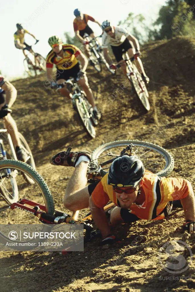 Young man falling off his bicycle in a race