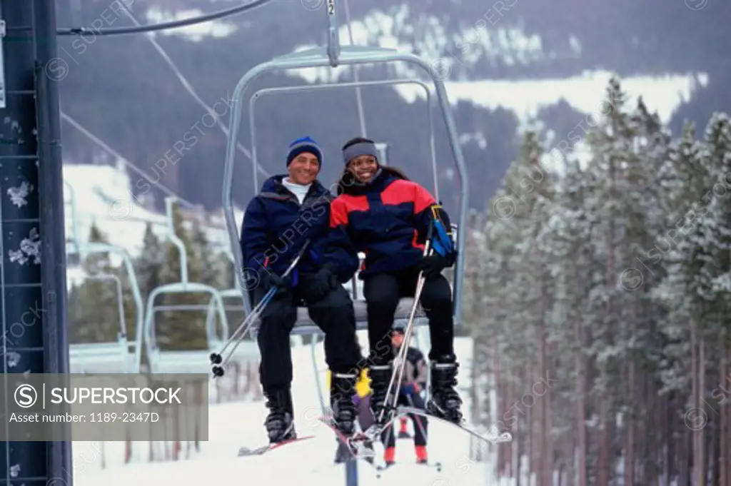 Young couple sitting on a ski lift