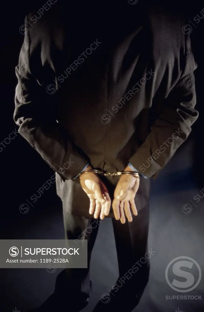 Rear view of a man in handcuffs