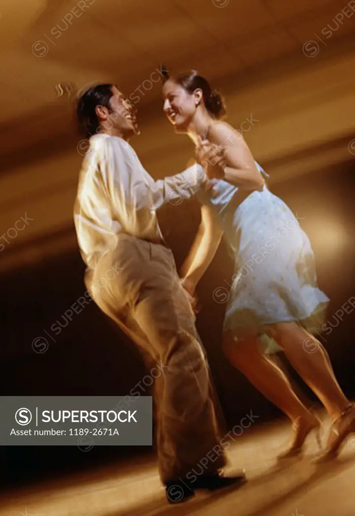 Low angle view of a young couple dancing in a nightclub