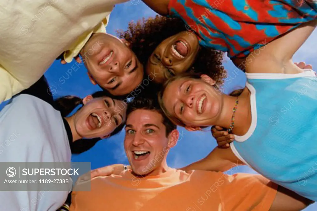 Low angle view of five people in a huddle