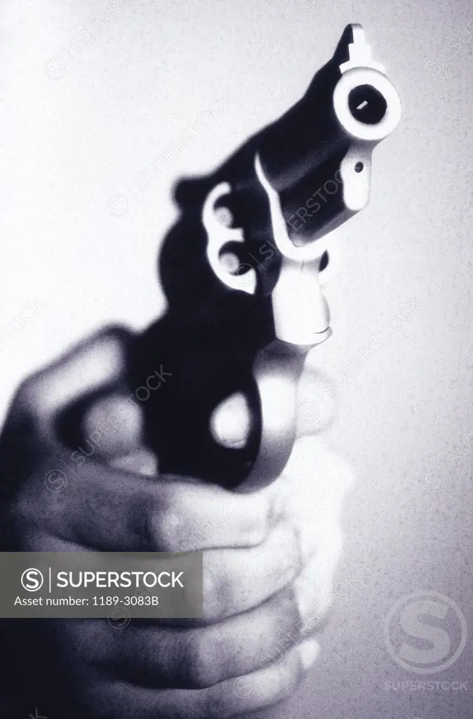 Close-up of a person holding a handgun