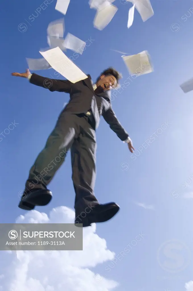 Low angle view of a businessman floating in mid air