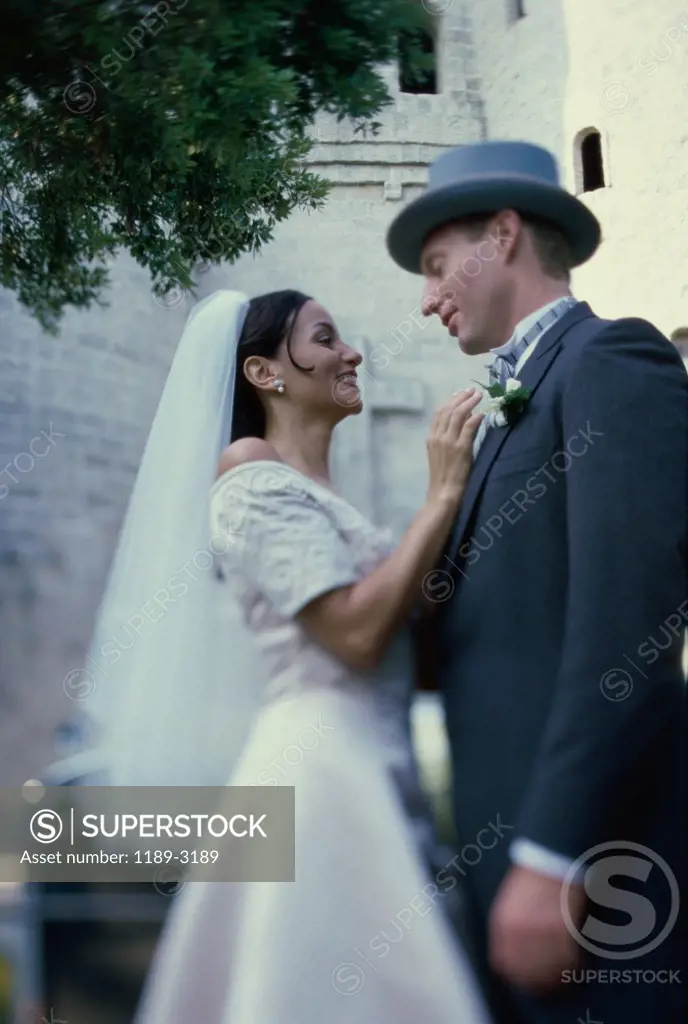 Side profile of a newlywed couple smiling
