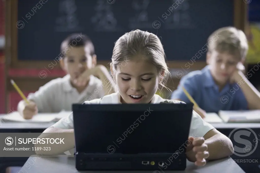 Children using a computer in a classroom