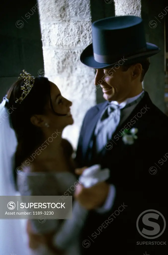 Side profile of a newlywed couple dancing
