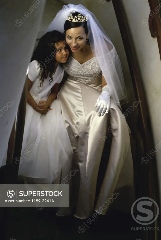 Bride and a bridesmaid near a staircase