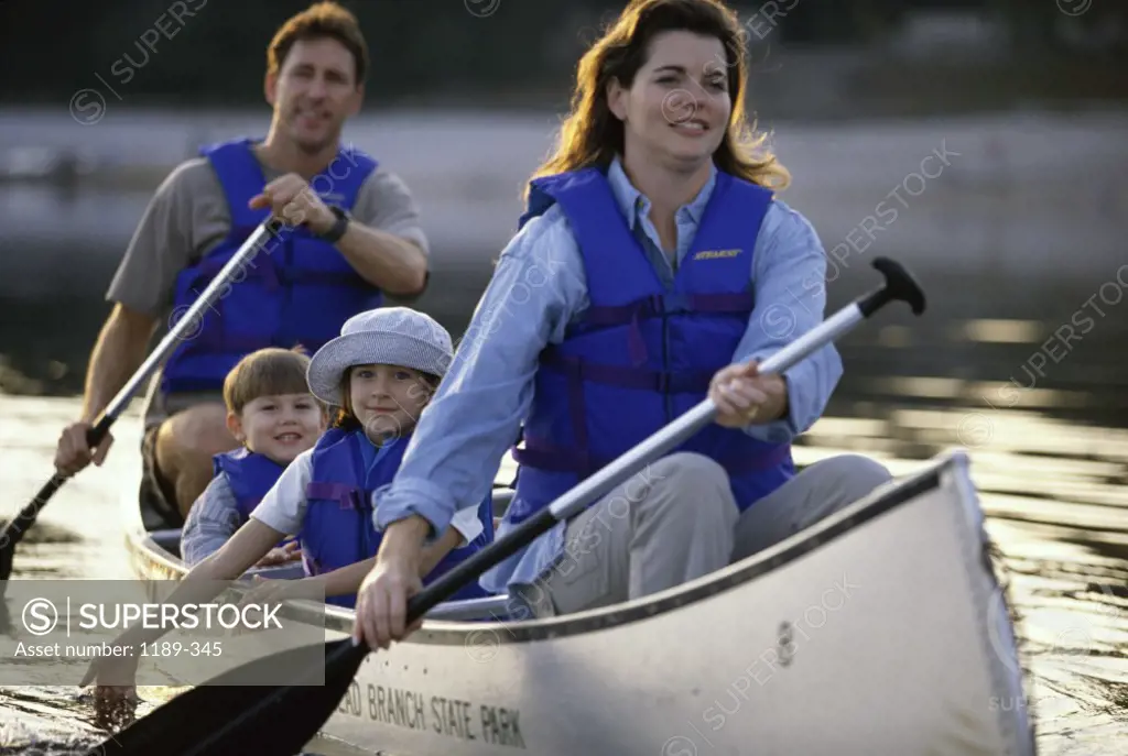 Parents canoeing with their son and daughter