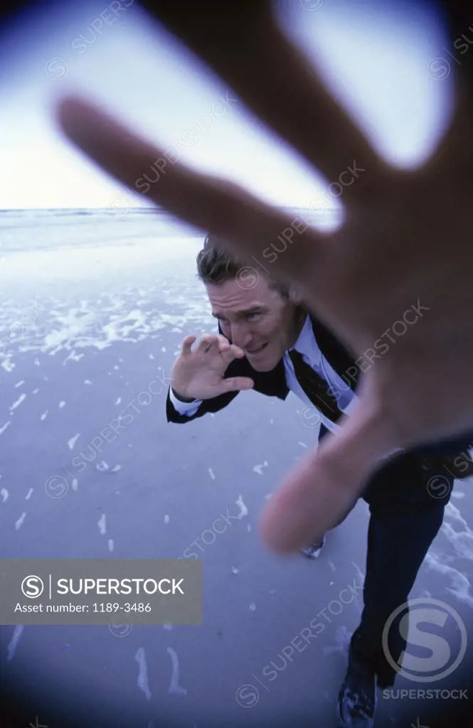 Businessman shielding his face with his hand