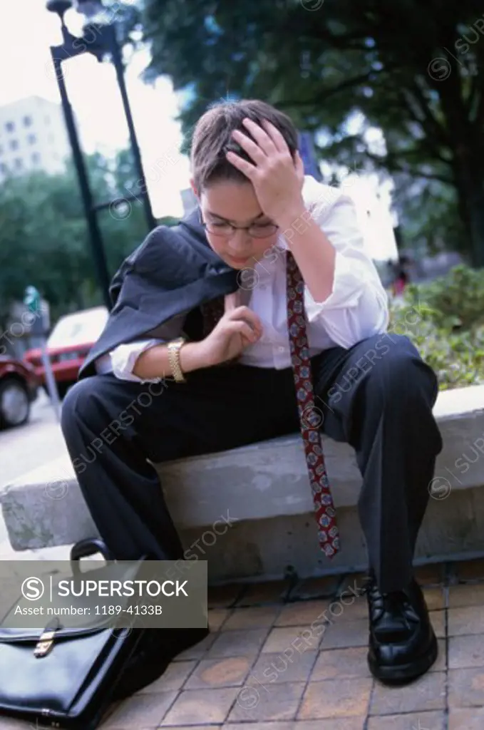 Boy wearing a business suit resting
