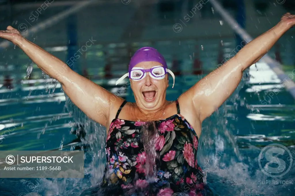 Portrait of a senior woman splashing in a swimming pool