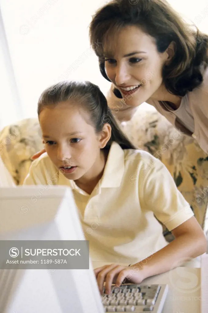 Mother and her daughter using a computer