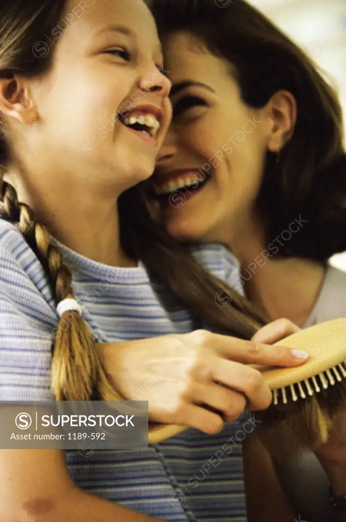Side profile of a mother and her daughter smiling
