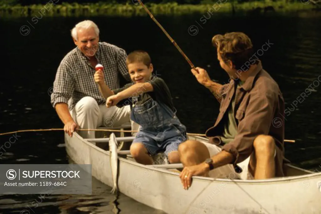 Grandfather sitting in a boat with his son and grandson