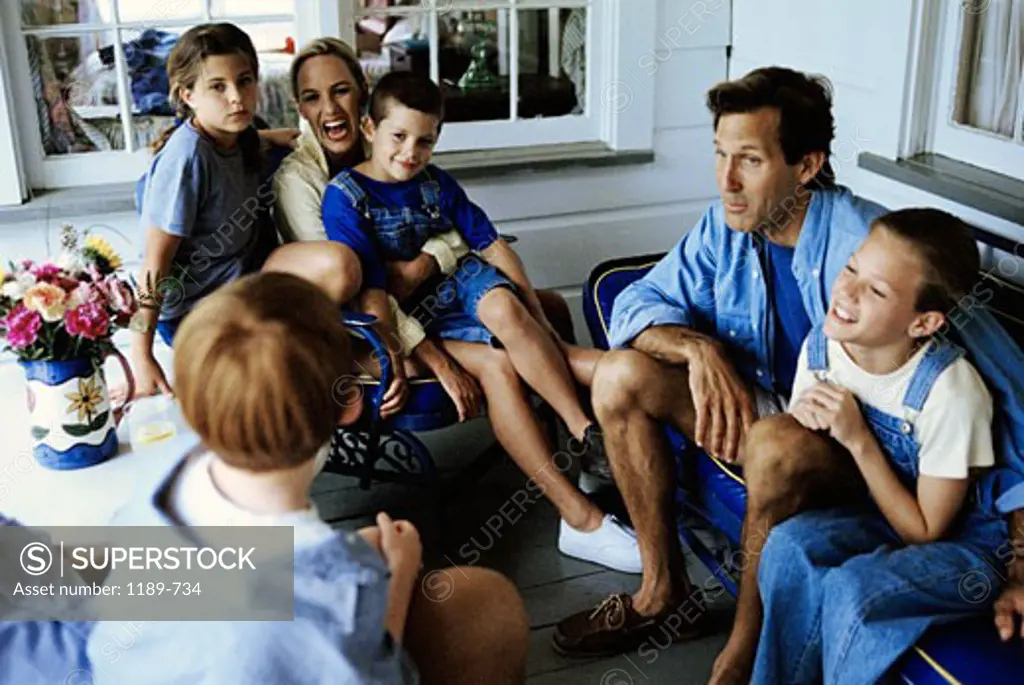 Mature couple sitting with their children