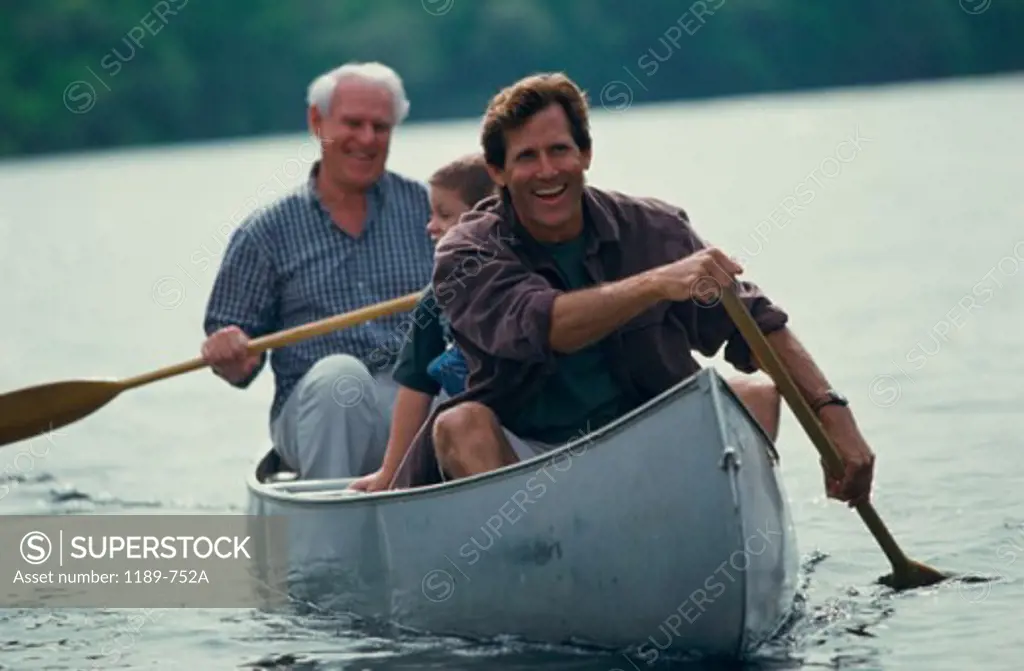 Father rowing a boat with his father and son in a lake