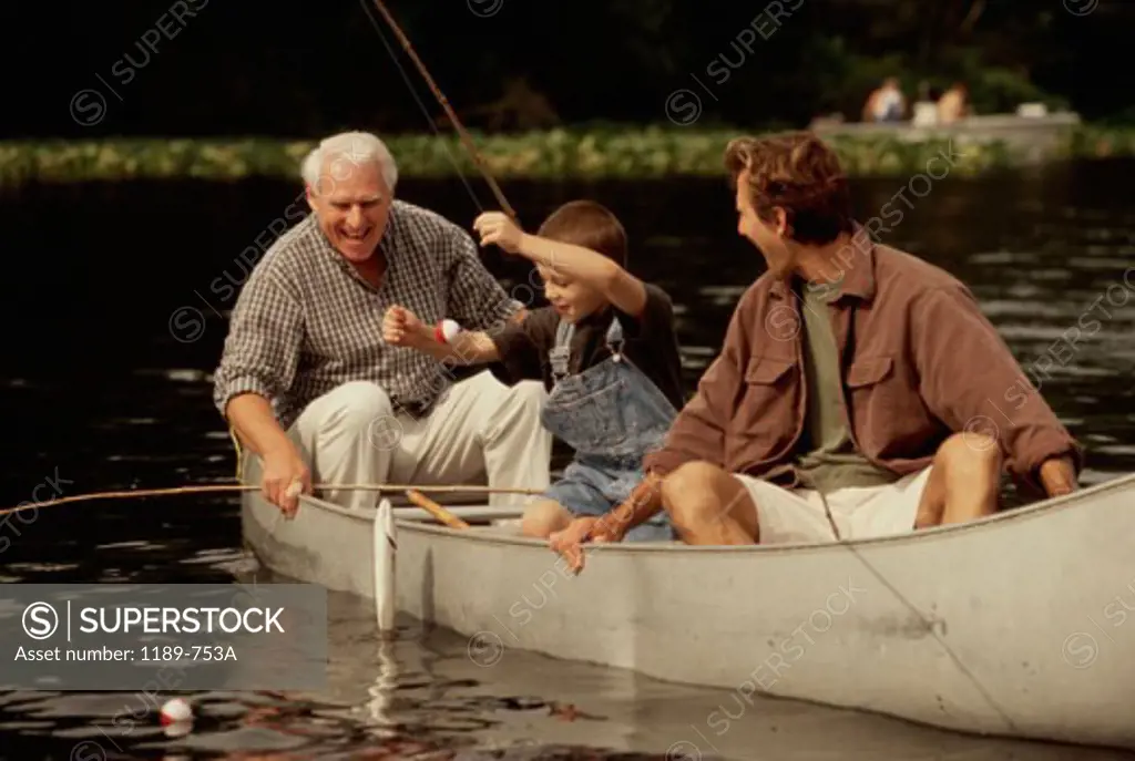 Grandfather with his son and grandson fishing in a lake