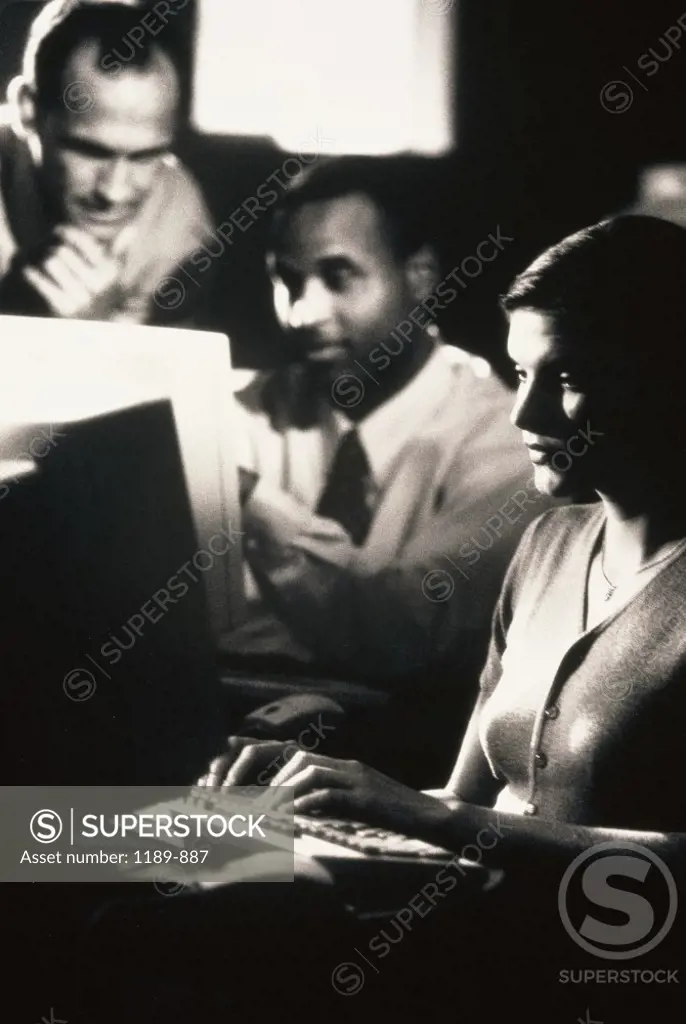 Group of business executives in front of computer monitors