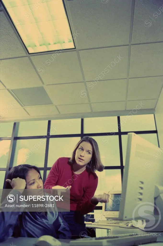 Two businesswomen working on a computer
