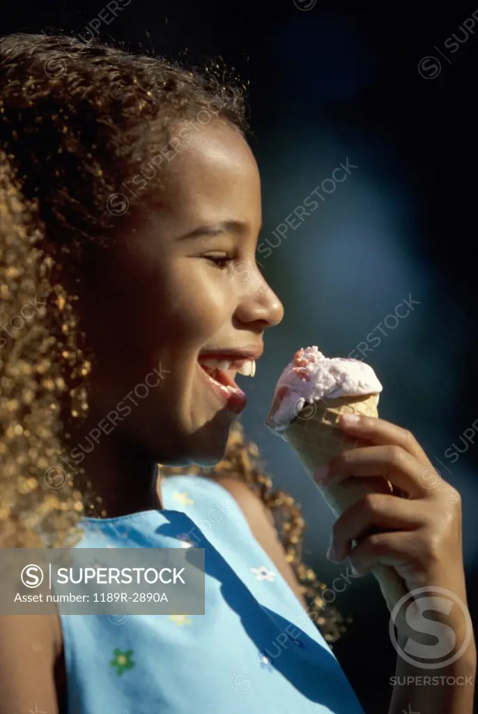 Side profile of a girl eating an ice cream