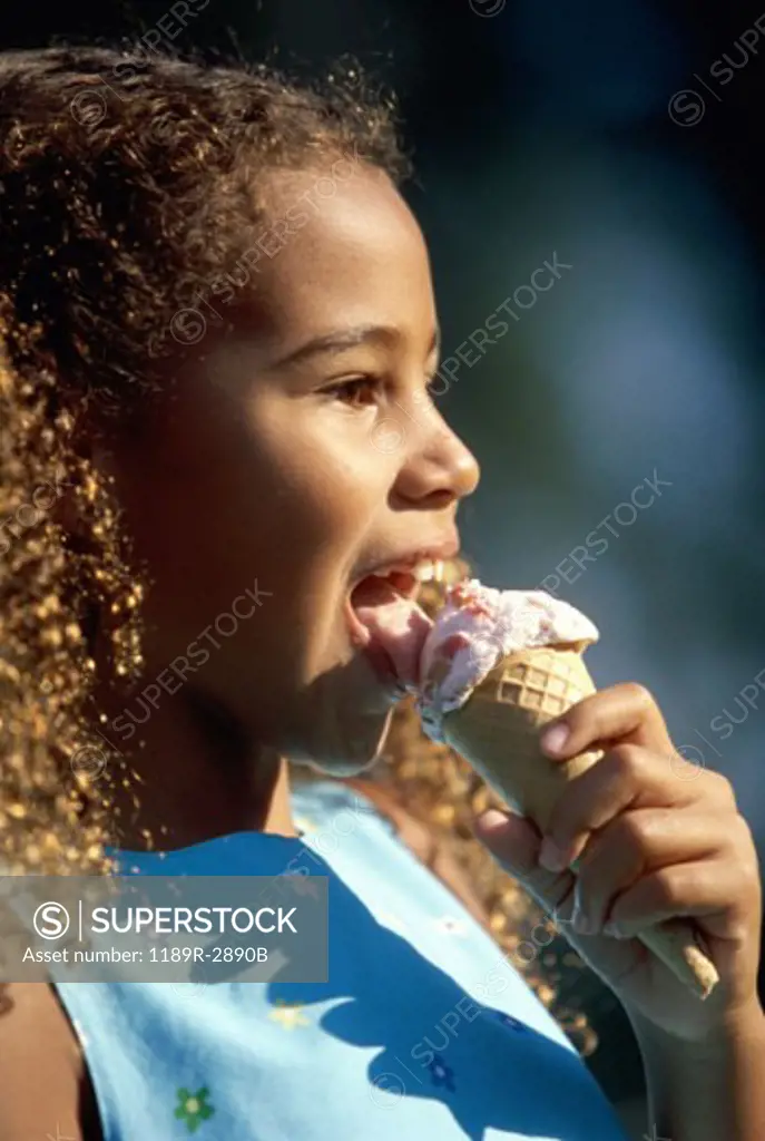 Side profile of a girl eating an ice cream