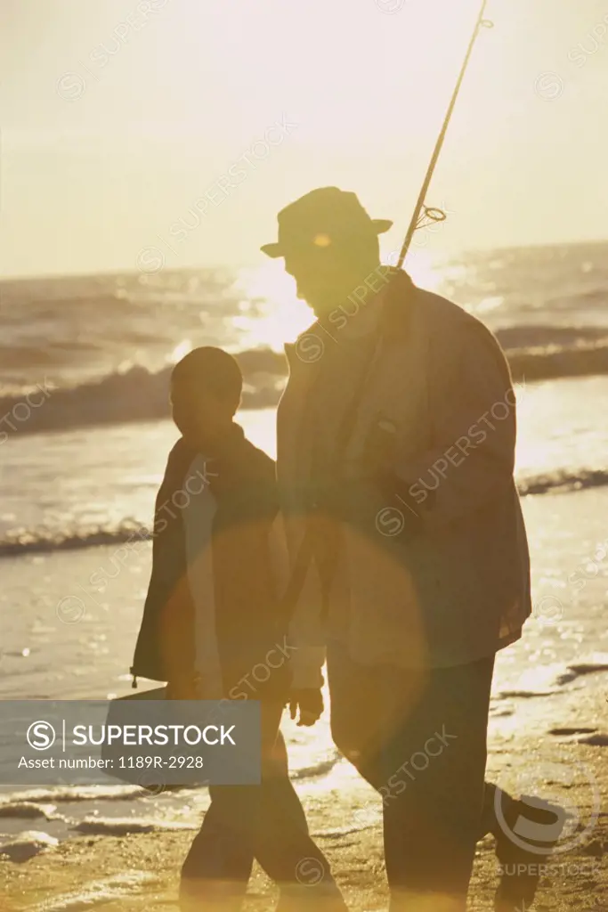 Father and son walking on the beach
