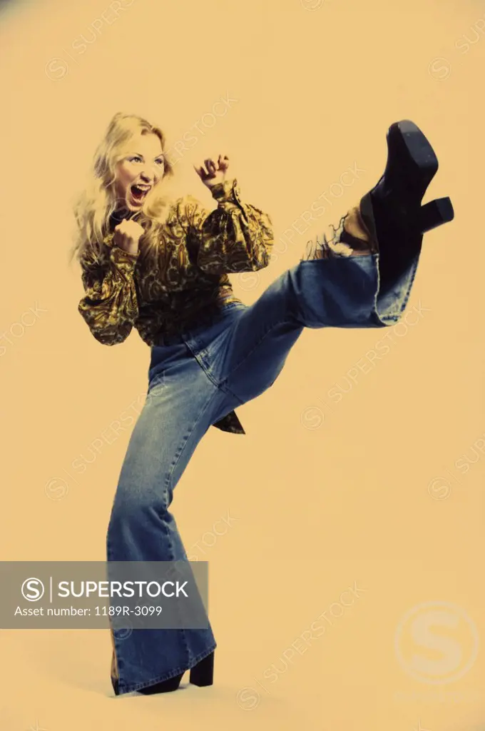 Young woman kicking