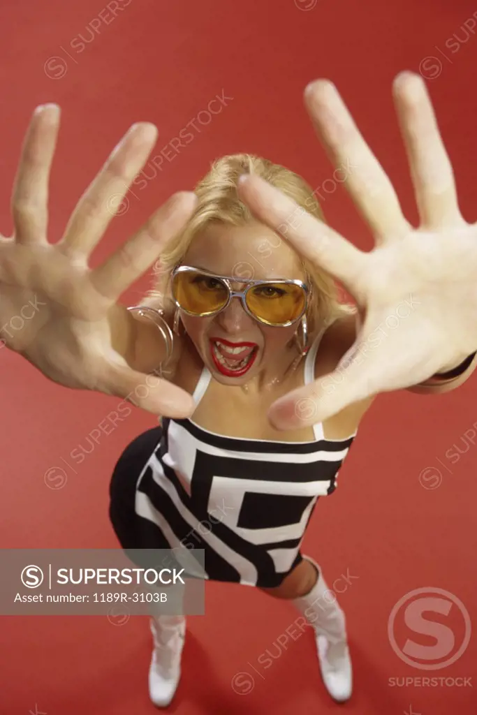 Portrait of a young woman with her hands in front of her face