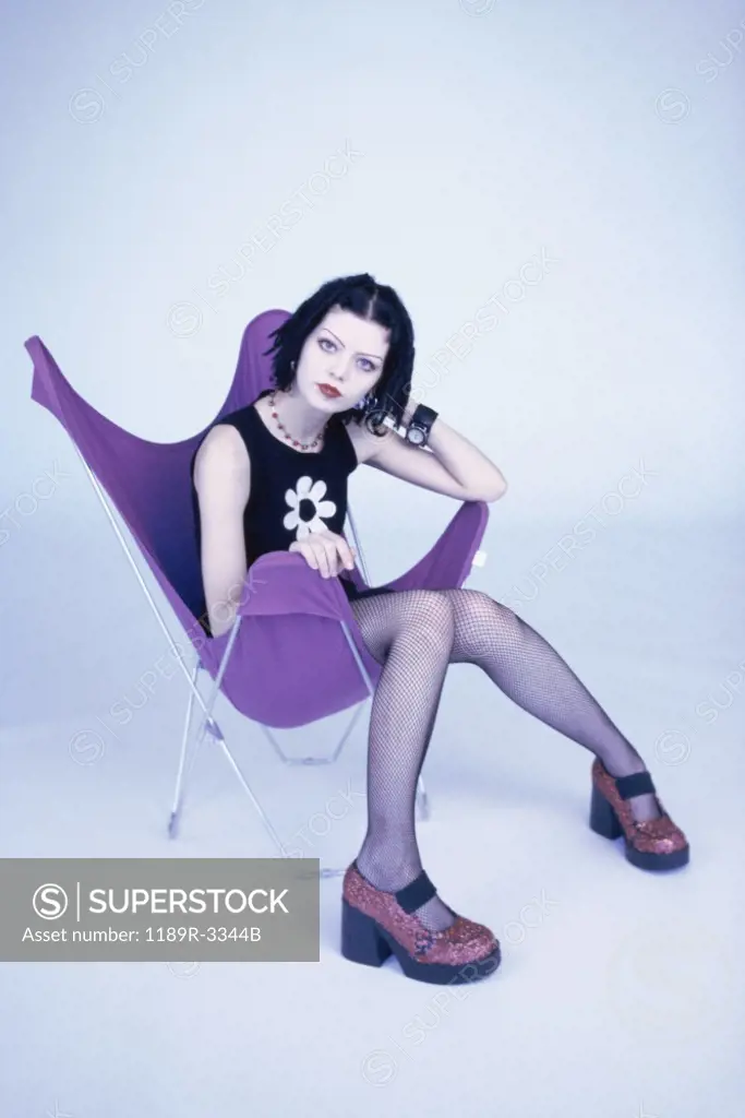 Portrait of a teenage girl sitting on a chair