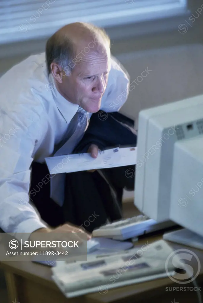 Side profile of a businessman working on a computer