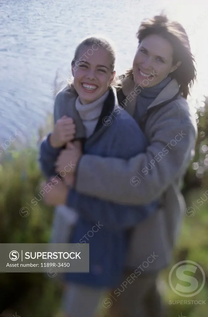 Portrait of a mother and her daughter holding each other