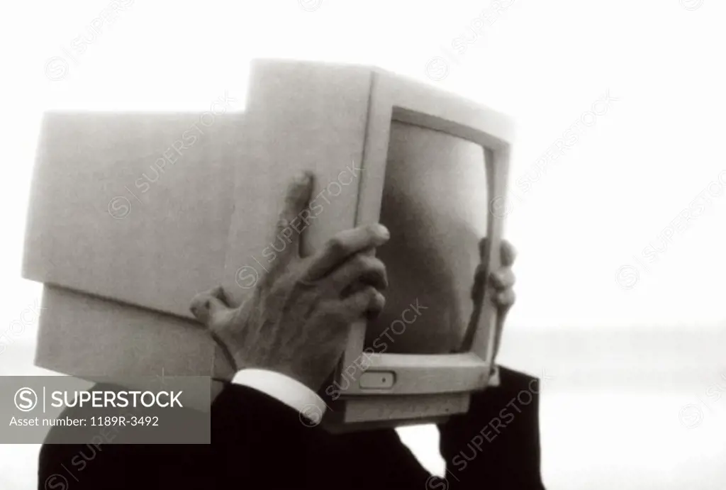 Side profile of a businessman with a computer monitor for a head