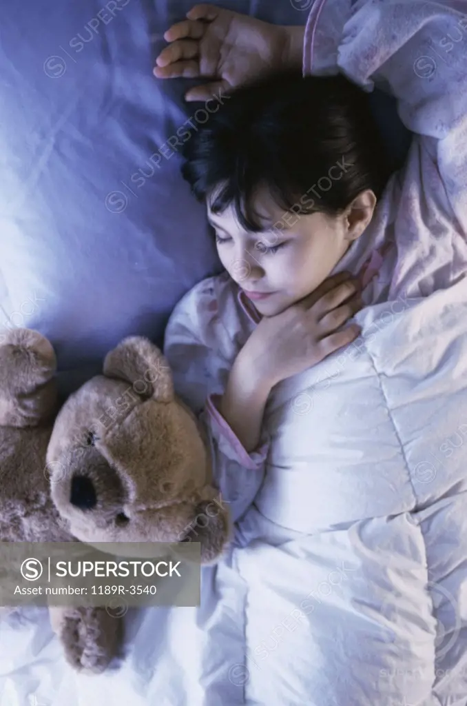 High angle view of a girl sleeping on a bed