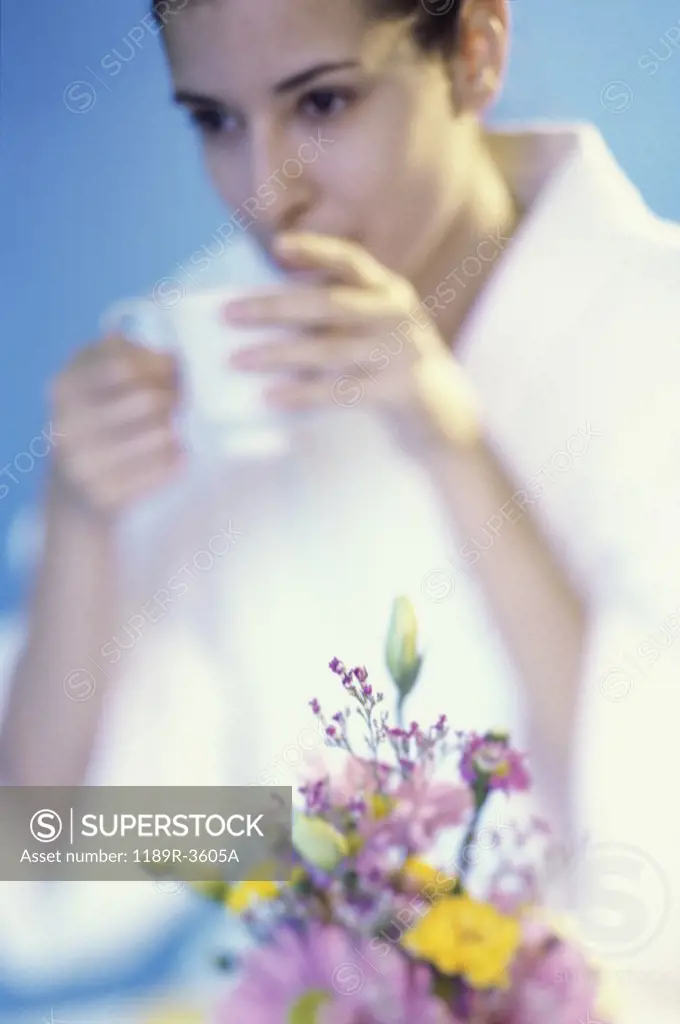 Young woman drinking from a cup