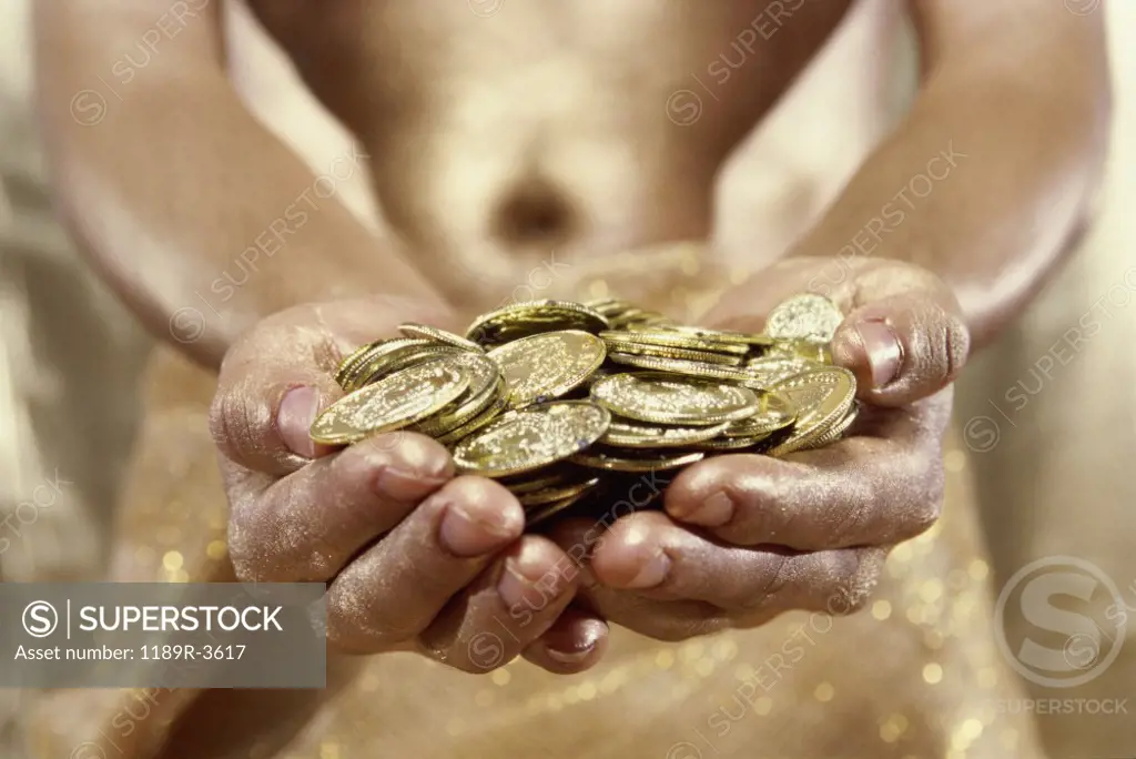 Person holding gold coins