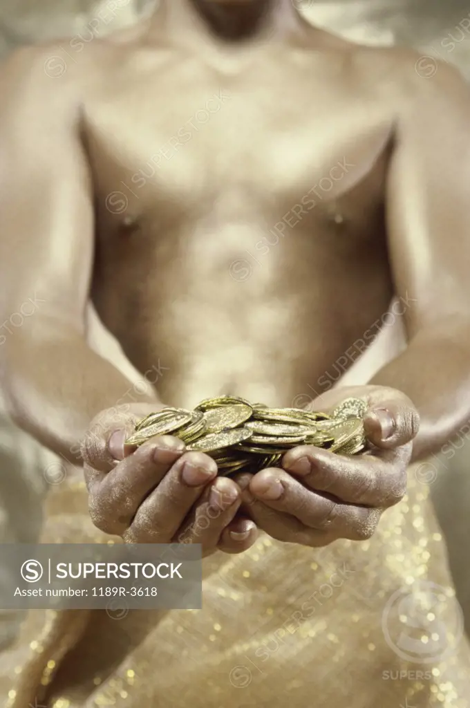 Person holding gold coins
