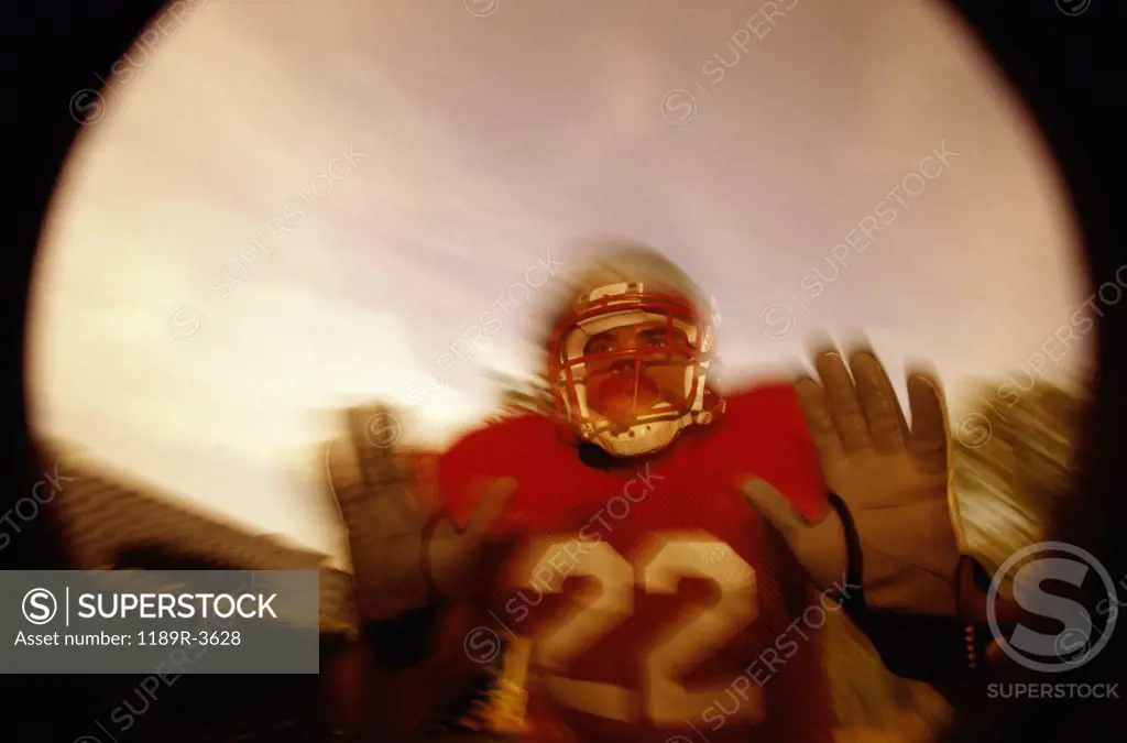 Low angle view of an American football player in a tackle pose