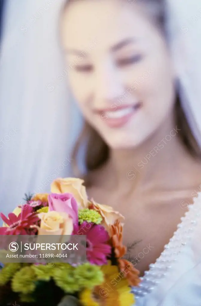 Portrait of a bride smiling holding a bouquet of flowers