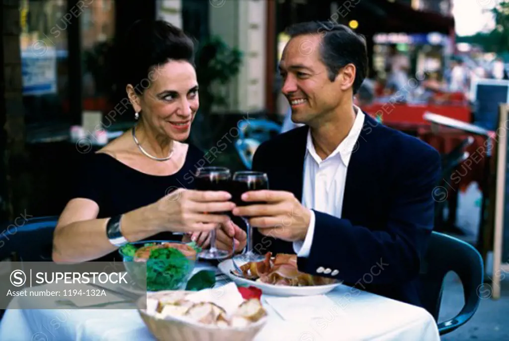 Mature couple toasting with red wine