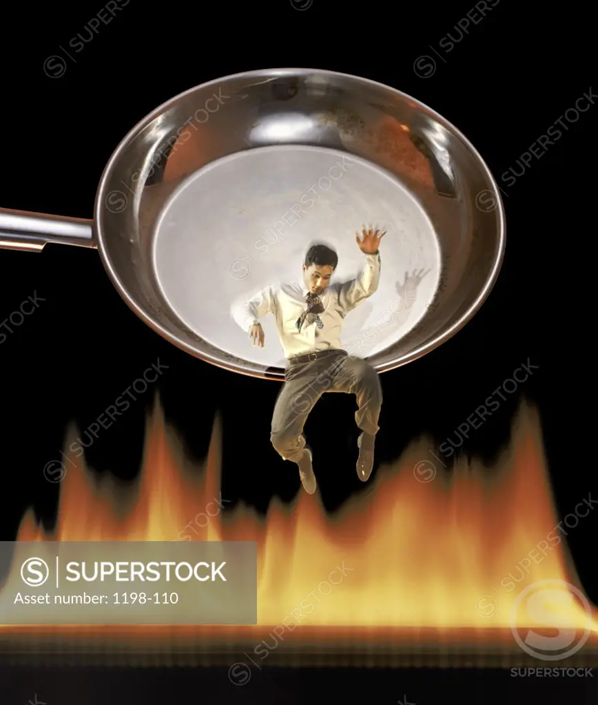 Businessman falling from the frying pan into the fire